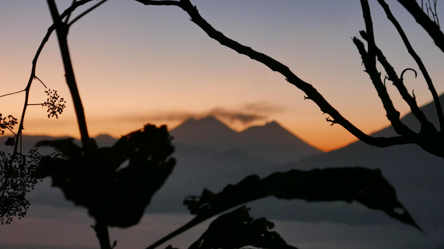 Just before sunrise at Lake Atitlan. Clouds hanging over Fuego volcano