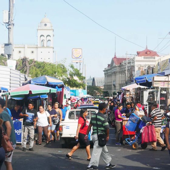 Street markets in 2a Calle Poniente in San Salvador. In the background the cathedral and Iglesia El Rosario can be seen