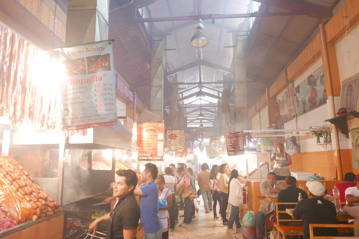 Meat being grilled in one of the covered markets in Oaxaca city