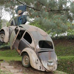 Crashed Volkswagen Beetle as a sculpture at Santo Domingo de Cerros near Antigua