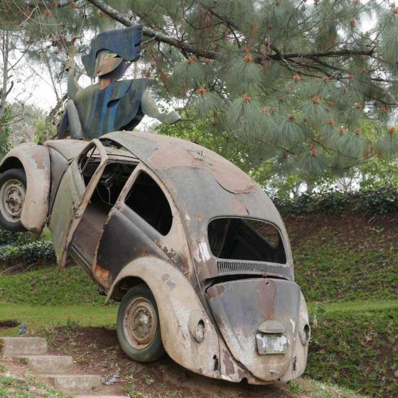 Crashed Volkswagen Beetle as a sculpture at Santo Domingo de Cerros near Antigua