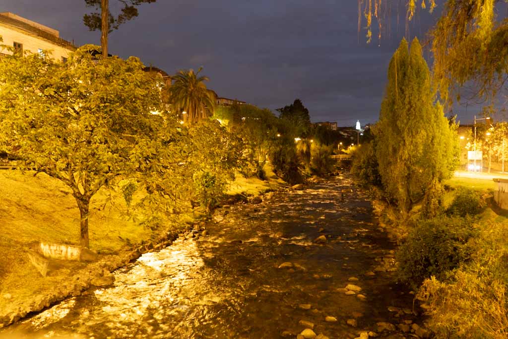 Tomebamba river by night in Cuenca