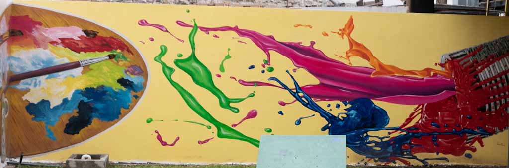 Splashed paint street art piece in Guayarte