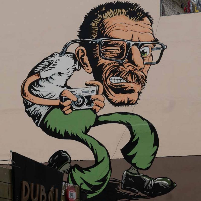 Street art: man with camera in Guayaquil