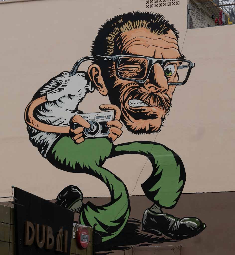 Street art: man with camera in Guayaquil
